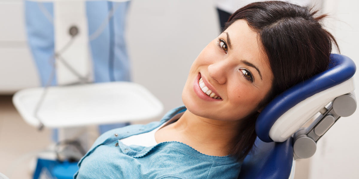 General Dentistry smiling young woman in exam room